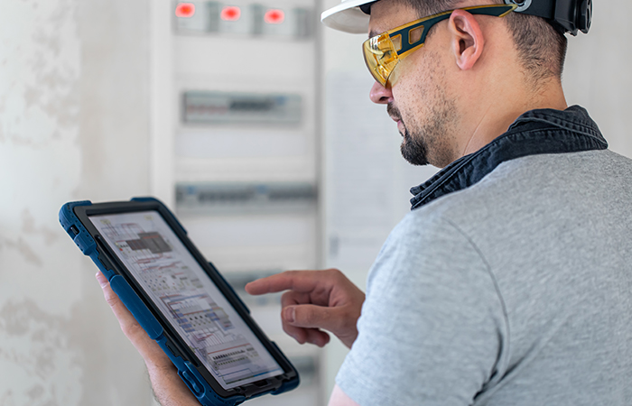 electrical-technician-looking-focused-while-working-switchboard-with-fuses_1.jpg